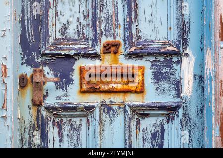 Alte, abgenutzte, rostige, blaue Haustür aus Holz. Schottland Stockfoto