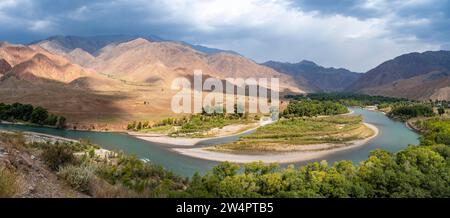 Grünes Flusstal mit dem Fluss Naryn zwischen Bergen, Berglandschaft in der Nähe von Kasarman, Region Naryn, Kirgisistan Stockfoto