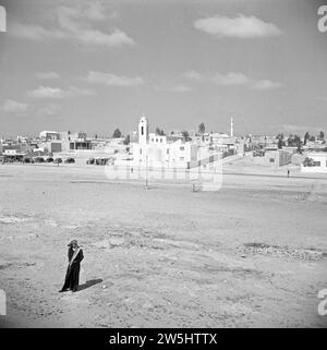 Blick auf das Dorf Zarka in Jordanien, arabischer Mann im Vordergrund ca. 1950-1955 Stockfoto