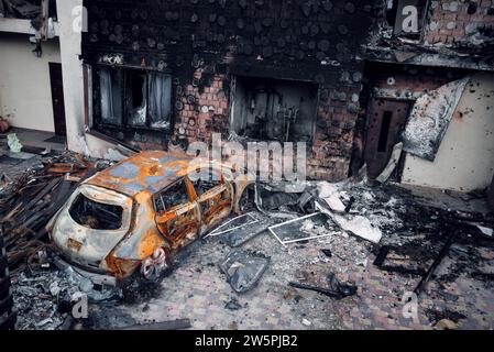 Irpin, Region Kiew, 2022. Zerstörtes Auto im Hof eines Hauses. Die Folgen des Raketenfeuers während des russischen Krieges gegen die Ukraine. Stockfoto