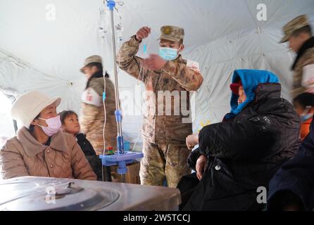 Linxia, Chinas Provinz Gansu. Dezember 2023. Soldaten leisten medizinischen Dienst für die von Erdbeben betroffenen Menschen in der Gemeinde Shiyuan, Jishishan County, nordwestchinesische Provinz Gansu, 21. Dezember 2023. Die chinesische Volksbefreiungsarmee (PLA) und die Volksarmee (PAPF) haben mehrere Rettungskräfte in Gebieten eingesetzt, die von Erdbeben betroffen sind, als Reaktion auf ein Erdbeben der Stärke 6,2, das die nordwestchinesische Provinz Gansu am späten Montag erschütterte. Quelle: Zhang Yongjin/Xinhua/Alamy Live News Stockfoto