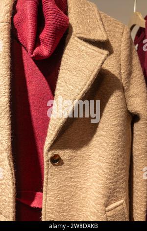 pressed wool coat hung in a clothing store Stockfoto