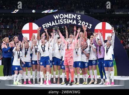 PA REVIEW OF THE YEAR 2023 Dateifoto vom 04/23 - England Spieler auf dem Podium heben die Trophäe nach dem Women's Finalissima im Wembley Stadium, London. Bilddatum: Donnerstag, 6. April 2023. Ausgabedatum: Freitag, 22. Dezember 2023. Stockfoto