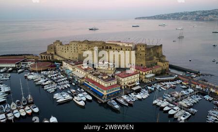 Luftbilddrohnenansicht des Seefrontschlosses Castel dell'Ovo im Golf von Neapel, Kampanien, Italien. Historisches mittelalterliches Festungsdenkmal am Meer. Stockfoto