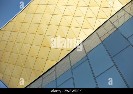 Modernes Gebäude aus Glas und Metall. Goldene Farbe in der Architektur des Gebäudes. Modernes Gebäude. Oberfläche im Palast spiegeln. Stockfoto