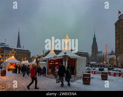 Hamburg: Weihnachtsmarkt an der Binnenalster, Weihnachtsdekoration, Verkaufsstände, Menschen, Schneefall, Blick auf das Rathaus in Hamburg, Deutschland Stockfoto