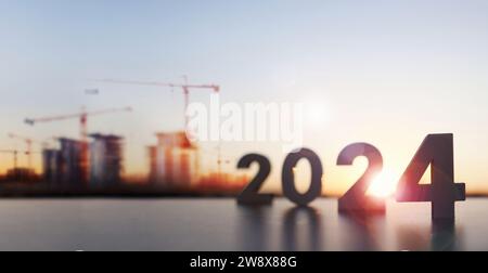 Das neue Jahr 2024, Sonnenaufgang, Architektur- und Baustellenhintergrund und Marktkonzept für Gebäude und Wohnungen Stockfoto