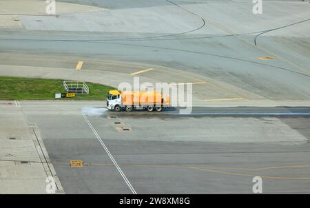 Reinigungswagen-Betrieb auf dem Taxiweg am internationalen Flughafen. Stockfoto