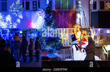 Lower Morden, Surrey, London, Großbritannien. Dezember 2023. Viele Bewohner der Lower Morden Lane schmücken jedes Jahr die Fassade ihrer Häuser. Besucher der Straße spenden an die Sammelboxen vor Ort und das Geld wird einem guten lokalen Zweck - dem Hospiz des Heiligen Raffael - zugeteilt. Quelle: Malcolm Park/Alamy Live News Stockfoto