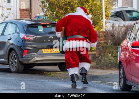 Radford, Coventry, Großbritannien. Dezember 2023. Der Weihnachtsmann wurde heute Morgen gesehen, wie er Kinder auf einer Wohnsiedlung in Radford besuchte, während eines spontanen Besuchs. Der Weihnachtsmann tanzte die Straße hinunter, nachdem er Kinder besucht hatte. Quelle: AG News/Alamy Live News Stockfoto