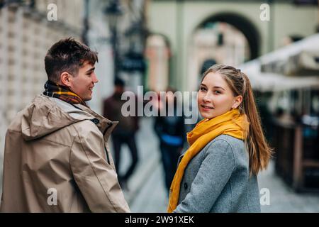 Eine Frau, die mit ihrem Freund auf der Straße über die Schulter schaut Stockfoto
