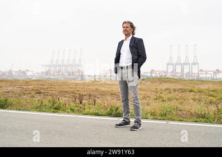 Senior-Geschäftsmann, der mit Händen in Taschen im Industrieviertel steht Stockfoto