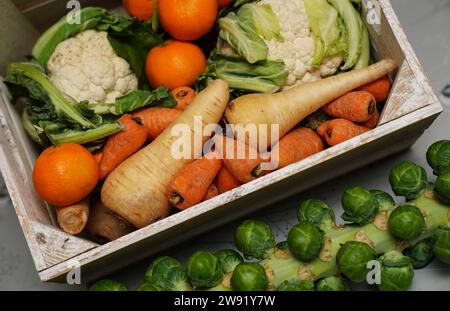 Stockbild einer Kiste mit frischem Obst und Gemüse, einschließlich Karotten, Blumenkohl, Pastinaken, Rosenkohl, Äpfel und Orangen. Bilddatum: Freitag, 22. Dezember 2023. Stockfoto