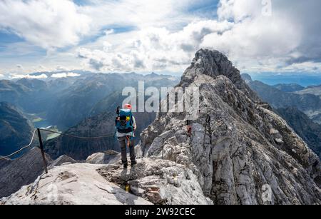 Klettersteig auf einem mit Stahlseil gesicherten Klettersteig, schmaler Felsgrat, Watzmann-Überquerung zur Watzmann Mittelspitze, Blick auf den Berg Stockfoto