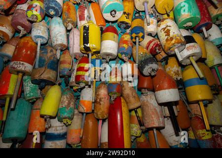 Die Wand ist mit farbenfrohen Bojen für Hummer und Krabben bedeckt. Stockfoto