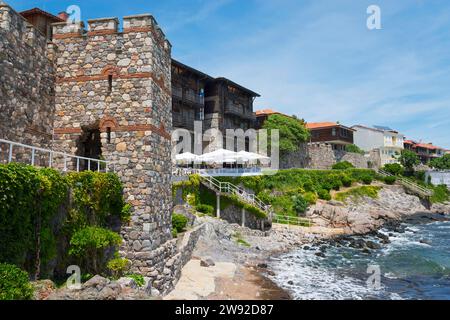 Traditionelles Steinhaus an einer felsigen Küste mit blauem Himmel und Meer im Hintergrund, architektonisch-historischer Komplex, südlicher Festungsmauer und Stockfoto