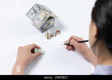 Haus aus Dollars, weißer Hintergrund, Handzeichnung, Modell Stockfoto