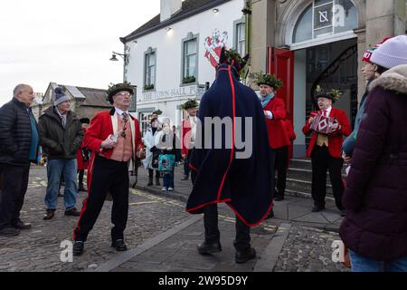 Ichmond, North Yorkshire, Großbritannien. Dezember 2023. Die Heiligabend-Tradition „Poor Old Hoss“ in Richmond, North Yorkshire. Auch bekannt als „T'owd Hoss“, und vermutlich aus dem 18. Jahrhundert, führt eine Gruppe von „Mummern“ in Jägerkostümen das Pferd durch das Stadtzentrum von Richmond, geht in Pubs und Cafés und singt sein besonderes Lied (24. Dezember 2023). (Foto: Pat Scaasi | MI News) Credit: MI News & Sport /Alamy Live News Credit: MI News & Sport /Alamy Live News Stockfoto