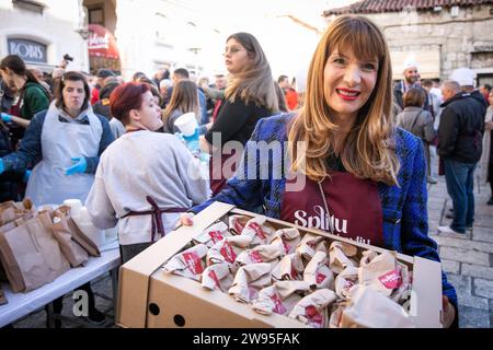 Kroatien, Split 241223. Etwa fünftausend Portionen Kabeljau und die gleiche Anzahl von Krapfen wurden in Peskaria in Split im Rahmen des Split with Love Events verteilt, das traditionell am Heiligabend stattfindet. Auf dem Foto: Alijana Vuksic. Foto: SASA Buric / CROPIX Copyright: XSasaxBuricx/xCROPIXxSasaxBuricx bakalar peskarija bozic44-241223 Stockfoto