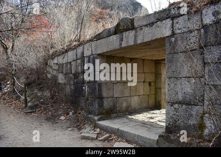 Durchgangstunnel in der Steinmauer, die entlang des Bergrückens in der Nähe des Daenammun-Tores im Bukhansan-Nationalpark verläuft Stockfoto