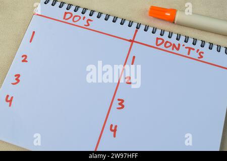 Konzept von "do's and Don't's" schreiben Sie auf ein Buch isoliert auf einem Holztisch. Stockfoto