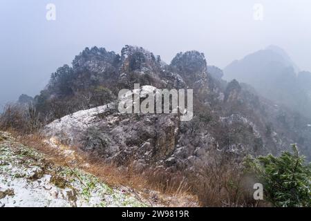 Antike Gebäude in Chinas Wudang-Bergen sind elegant mit einer Schneeschicht dekoriert und bieten eine harmonische Mischung aus Natur und Architektur. Stockfoto