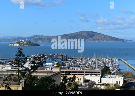 Blick auf die angedockten Boote am Pier 39 in Fisherman's Wharf mit Alcatraz Island im Hintergrund Stockfoto