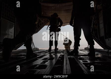 Soldaten der US-Armee, die der 165th Quartermaster Brigade Aerial Delivery Company-Airborne Det 1 zugeteilt wurden, führen während der Operation Desert Redhawk 2 am 25. Dezember 2023 an einem unbekannten Ort innerhalb des Verantwortungsbereichs des US-Zentralkommandos Luftsprünge von einem C-130J Super Hercules durch. Mehr als 50 US-Fallschirmjäger und Qatari Joint Special Forces führten während der Operation eine statische Flugausbildung durch. Die Durchführung routinemäßiger Luft- und Flugabwurfmissionen unterstützt die Beziehungen zur QJSF-Community und ermöglicht ein Cross-Training zu den spezifischen Flugabwurfmissionen zwischen Th Stockfoto