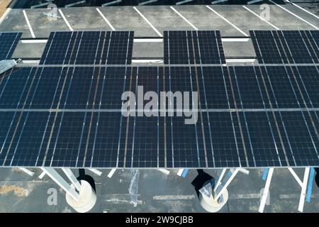 Ausfall der Photovoltaik-Technologie, die in die städtische Infrastruktur integriert ist. Hurrikan-Windschäden an Solarpaneelen, die als Schattendach über dem Parkplatz installiert sind Stockfoto