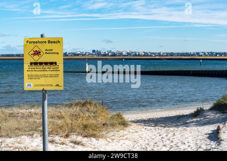 Ein Warnschild zur Wasserverschmutzung am Strand in der Nähe der Mündung des Mill Stream in Port Botany und Botany Bay in Sydney, New South Wales, Australien Stockfoto