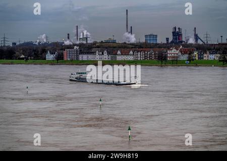 Frachtschiff auf dem Rhein bei Duisburg-Laar, Häuser an der Deichstrasse, Industriekulisse des ThyssenKrupp Stahlwerks in Bruckhausen, Hochwasser, NRW, Deutschland, Binnenschifffahrt *** Frachtschiff auf dem Rhein bei Duisburg-Laar, Häuser an der Deichstraße, Industriehintergrund des ThyssenKrupp Stahlwerks in Bruckhausen, Hochwasser, NRW, Deutschland, Binnenschifffahrt, Binnenschifffahrt Stockfoto