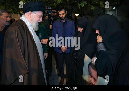 Teheran, Iran. Dezember 2023. Der oberste iranische Führer Ayatollah ALI KHAMENEI (L) spricht mit den Verwandten des Militärberaters des Korps der Iranischen Islamischen Revolutionsgarden (IRGC) Seyed Razi Mousavi, einem hochrangigen Befehlshaber der Quds-Truppe des Korps der Islamischen Revolutionsgarde Irans, der am 25. Dezember bei einem israelischen Streik in Syrien getötet wurde, in Teheran. (Foto: © Iranian Supreme Leader's Office via ZUMA Press Wire) NUR REDAKTIONELLE VERWENDUNG! Nicht für kommerzielle ZWECKE! Stockfoto