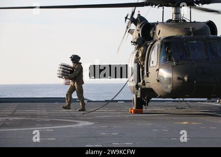 PAZIFIK - Soldaten des 2-158. Sturmhubschrauber-Bataillons der Armee liefern Vorräte an die Besatzung des Küstenkampfschiffs USS Cincinnati (LCS 20), während sie UH-60M Blackhawk-Deck-Qualifikationen auf dem Flugdeck des Schiffes durchführen, um die Übung Steel Knight 23.2 zu unterstützen. Steel Knight ist eine dreiphasige Übung, die die I Marine Expeditionary Force in der Planung, dem Einsatz und der Kontrolle einer gemeinsamen Truppe gegen eine Peer- oder Near-Peer-Gegner-Kampftruppe trainieren soll und die bestehenden Fähigkeiten der Marine Air-Ground Task verbessern soll Stockfoto