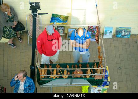 Mann Straßenverkäufer, der Souvenirs auf dem Bürgersteig auf der Straße verkauft. September 2020. Kiew, Ukraine Stockfoto