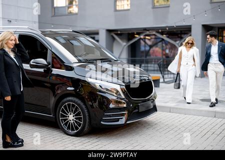 Geschäftsleute laufen zu Fuß zum Taxi im Minibus Stockfoto