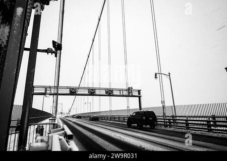 Autos überqueren die Angus-L-Macdonald-Brücke über den Hafen während eines Schneesturms in Halifax, Nova Scotia, Kanada. Stockfoto