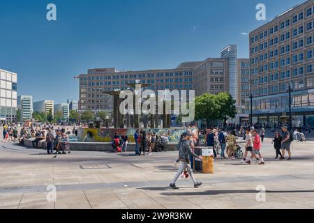 Menschen am Brunnen am Alexanderplatz, einem beliebten Treffpunkt in der deutschen Hauptstadt Berlin Stockfoto