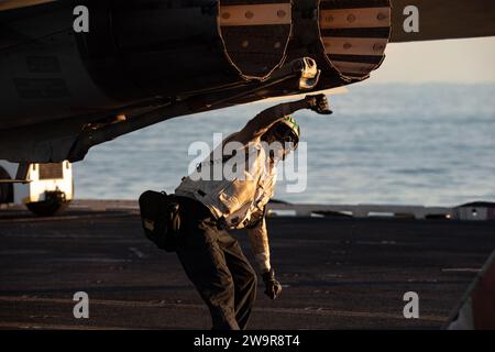 Luftfahrt-Strukturmechaniker (Sicherheitsausrüstung) 2. Klasse Keoni Brown, zugewiesen zu den 'Tomcatters' der Strike Fighter Squadron (VFA) 31, letzte Prüfung einer F/A-18E Super Hornet auf dem Flugdeck des größten Flugzeugträgers der worldÕs USS Gerald R. Ford (CVN 78), 11. Dezember 2023. Die Gerald R. Ford Carrier Strike Group ist derzeit im Mittelmeer tätig. Die USA halten nach vorne entsandte, bereitwillige und positionierte Kräfte bereit, um Aggressionen abzuschrecken und Sicherheit und Stabilität auf der ganzen Welt zu unterstützen. (Foto der U.S. Navy von Mass Communication Specialist 3rd Class Maxwell Orlosky) Stockfoto