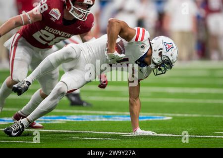 San Antonio, TX, USA. Dezember 2023. Der Arizona Wildcats Wide Receiver Tetairoa McMillan (4) versucht, aufrecht zu bleiben, nachdem er während des Valero Alamo Bowl NCAA-Fußballspiels zwischen den Arizona Wildcats und den Oklahoma Sooners in San Antonio (Texas) einen Fang gemacht hat. Trask Smith/CSM/Alamy Live News Stockfoto