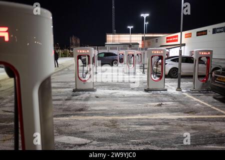 Göteborg, Schweden - dezember 09 2022: Autos laden nachts an Tesla Supercharger auf Stockfoto