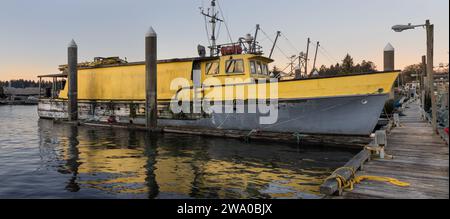 Das offene Tor am Hafen von Peninsula Dock beherbergt ein altes hölzernes Fischerboot, das repariert werden muss Stockfoto