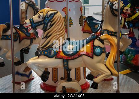 Altes Kinderkarussell mit Pferdenaht. Fliegende Spielzeugtiere im Vergnügungspark Stockfoto
