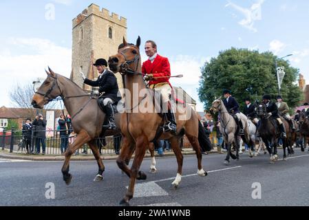 High Street, Maldon, Essex, Großbritannien. Januar 2024. Die Puckeridge and Essex Union Hunt (gegründet durch die Zusammenlegung der Essex mit Farmers & Union Hunt und der Puckeridge Hunt) zogen ihre Pferde und Hunde entlang der Maldon High Street zu ihrem jährlichen Neujahrstreffen. Hunt-Anhänger, Mitglieder der Öffentlichkeit und Action Against Foxhunting Anti-Hunt-Demonstranten nahmen an der Veranstaltung Teil. Fahrer, die an der St. vorbeifahren Peterskirche Stockfoto