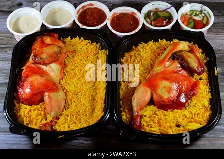 Kairo, Ägypten, 26. Dezember 2023: Hadramout Antar Restaurant Chicken mandi kabsa mit langem Basmatireis, serviert mit Tomaten-Dakos-Sauce, grünem Salat und Stockfoto