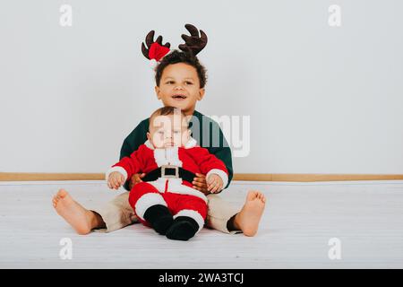 Bild von zwei lustigen Jungs, die weihnachtsoutfit tragen Stockfoto