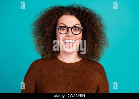 Porträt der verrückten Frau Brille tragen Copywriter Geek in Computern macht lustige glückliche Grimasse staunend isoliert auf blauem Hintergrund. Stockfoto