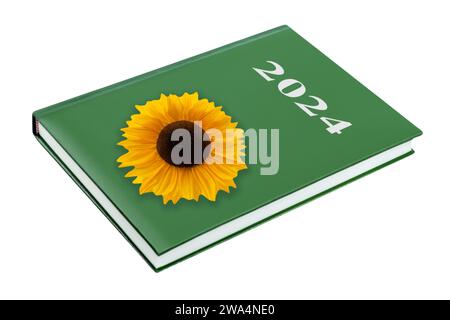 Grünes Kalenderbuch 2024 und Sonnenblume isoliert auf weißem Hintergrund Stockfoto