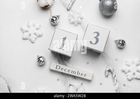 Kalender mit Datum vom 13. DEZEMBER und Weihnachtsdekor auf weißem Marmorhintergrund Stockfoto