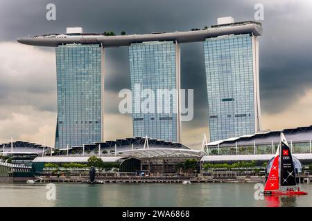 Touristenboote, die an den ikonischen Marina Bay Sands am Ufer der Stadt Singapur vorbeifahren Stockfoto