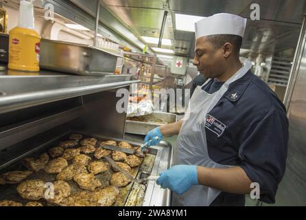 US-Streitkräfte. 171213KA046-004 MITTELMEER (13. Dezember 2017) - Culinary Specialist 1st Class Charles Bemley grillt Huhn für die Besatzung an Bord des Arleigh Burke-Klasse-Raketenzerstörers USS Carney (DDG 64), 13. Dezember 2017. Carney, nach Rota, Spanien, stationiert, befindet sich auf seiner vierten Patrouille im Gebiet der 6. US-Flotte, um regionale Verbündete und Partner sowie nationale Sicherheitsinteressen der USA in Europa zu unterstützen. (Foto der US Navy von Mass Communication Specialist 2nd Class James R. Turner/veröffentlicht) Stockfoto